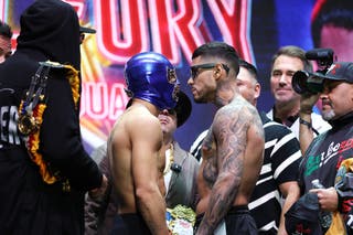 Teofimo Lopez (masked) and Arnold Barboza Jr stare each other down